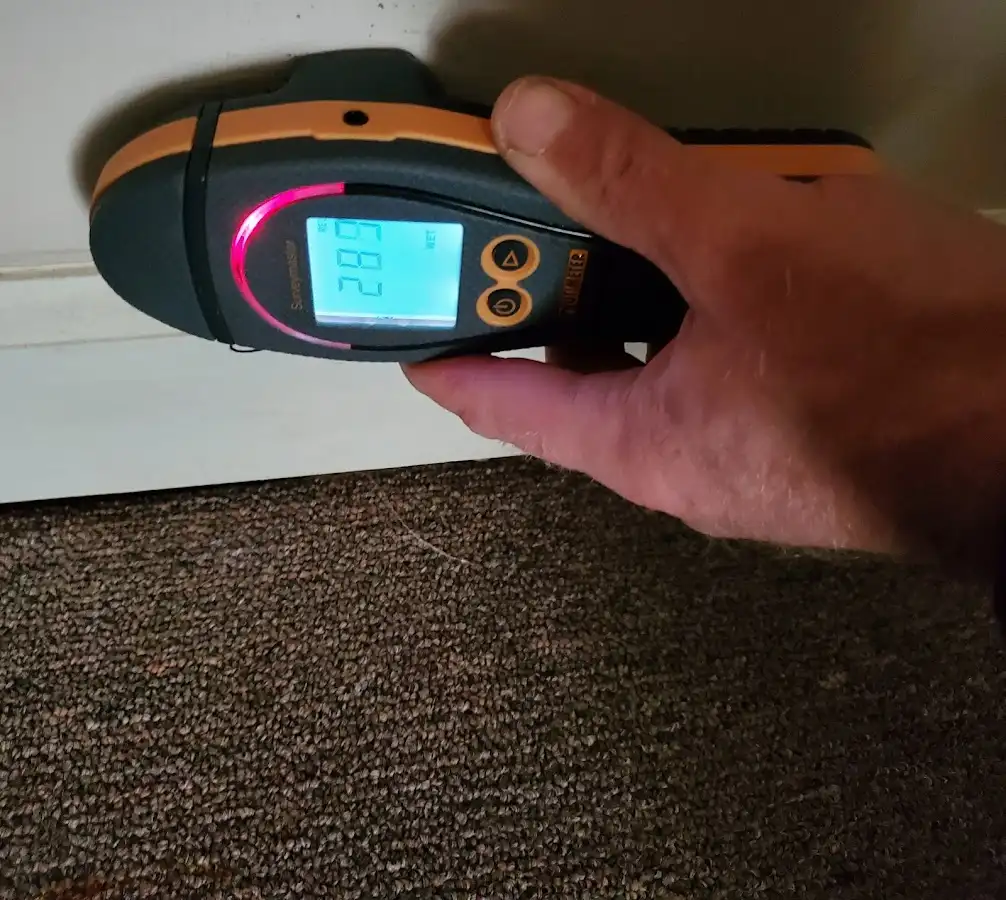 Moisture detection at baseboard during Storm Damage Restoration in Canton